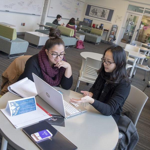 Two students looking at laptop